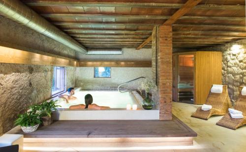 a woman in a bath tub in a room at El Porxo de la Barraca in Caserras