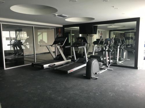 a gym with several tread machines and mirrors at LUJO CONFORT SEGURIDAD Quo 101 in Guayaquil