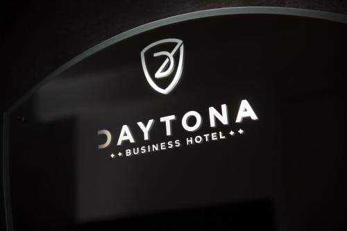 a black and white photo of a sign on a wall at Daytona Business Hotel in Collecchio