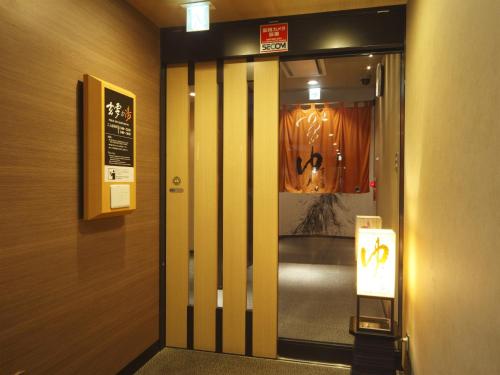 a elevator door with a sign in a building at APA Hotel Sendai Eki Itsutsubashi in Sendai