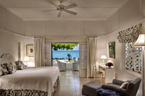 a bedroom with a bed and a view of the ocean at Half Moon in Montego Bay