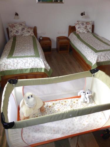 two bunk beds with stuffed animals sitting on them at Tündérgyöngye Apartmanház in Zirc