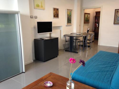 a living room with a bed and a table with a tv at Milano Canal Apartments in Milan