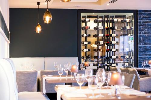 a restaurant with tables and chairs and wine racks at Portmarnock Resort & Jameson Golf Links in Portmarnock
