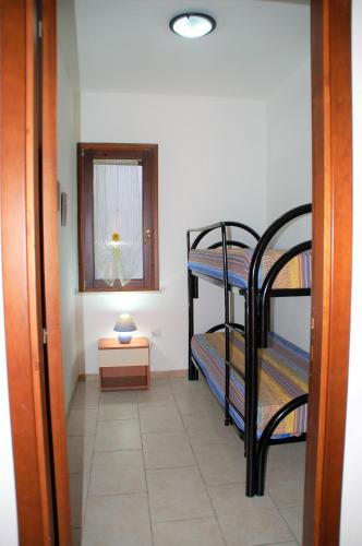 a hallway with two bunk beds in a room at Stefania Apartments in Porto Pino