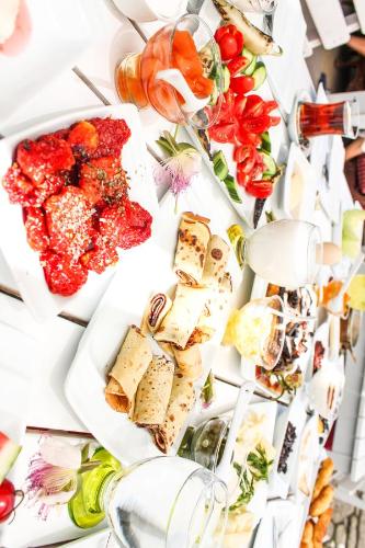 a table filled with cheese and other food items at Alacati Lucky Angel Hotel in Alacati