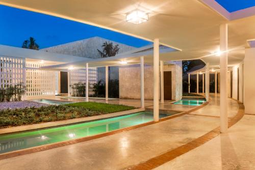 a house with a swimming pool at night at El Beso Adults Only at Ocean Riviera Paradise All Inclusive in Playa del Carmen