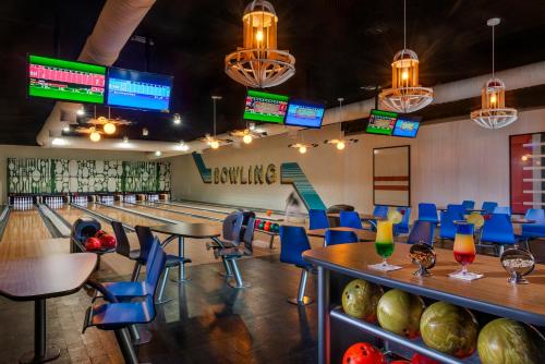 a dining room with tables and chairs and televisions at El Beso Adults Only at Ocean Riviera Paradise All Inclusive in Playa del Carmen