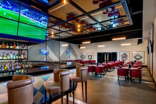 a bar with a bunch of chairs and a large screen at Ocean Riviera Paradise All Inclusive in Playa del Carmen