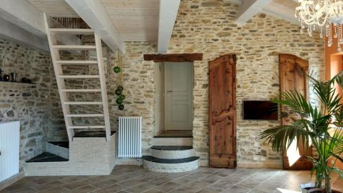 a room with a stone wall and a wooden door at Casa Pablo in Badalucco