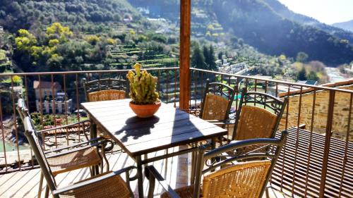 a table with a plant on top of a balcony at Casa Pablo in Badalucco