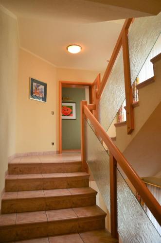 a staircase in a home with wooden railings at Wirtshaus & Hotel Zur Alten Brauerei Zapf in Uettingen