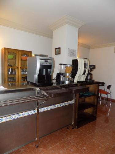 a kitchen with a counter with several appliances on it at Hotel Royal in Ronda