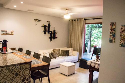 a living room with a white couch and a table at Praia do Forte in Praia do Forte