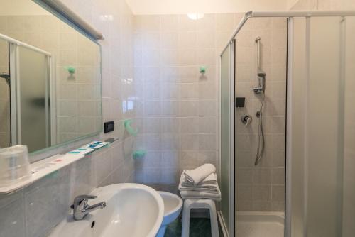a bathroom with a sink and a shower at Hotel Santa Maria in Finale Ligure