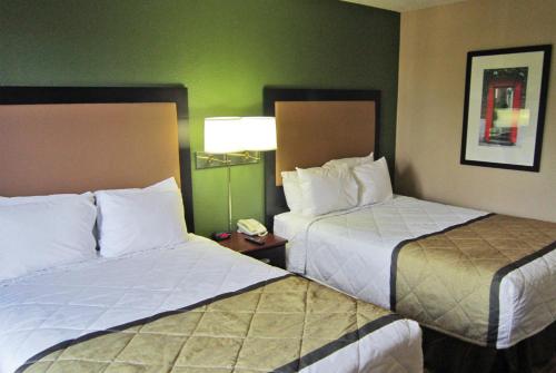 a hotel room with two beds and a phone at Extended Stay America Suites - Chesapeake - Crossways Blvd in Chesapeake