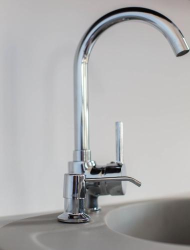 a kitchen sink with a chrome faucet at Noclegi Prestige in Nowy Sącz