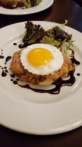 a fried egg on a white plate with a salad at Garrison Hotel in Sheffield