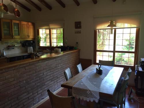 a kitchen with a wooden table and chairs in a room at La Maria Josefa in San Rafael