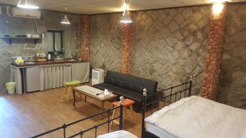 a room with a couch and a table and a kitchen at Jiufen Walk Inn 3x3 in Jiufen