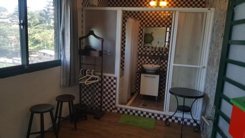 a bathroom with two stools and a large mirror at Jiufen Walk Inn 3x3 in Jiufen