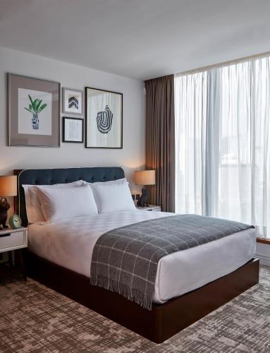 a bedroom with a large bed and a large window at Little Tai Hang in Hong Kong