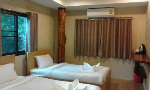 Ένα ή περισσότερα κρεβάτια σε δωμάτιο στο Treasure Inn Khaoyai