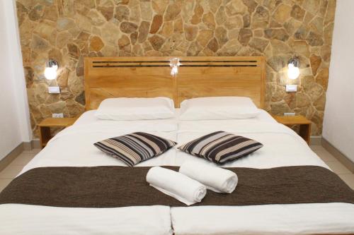 a bedroom with two beds with pillows on it at Alona's Coral Garden Resort (Adult-Only) in Panglao