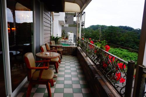 a balcony with tables and chairs on a building at Villa High Wharf in Wanli District