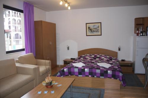 - un salon avec un lit et un canapé dans l'établissement Studio Moni, à Pamporovo