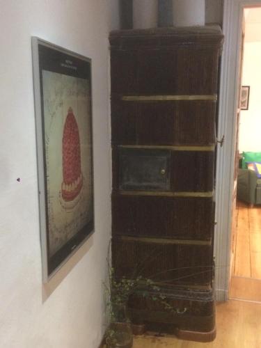 a wooden book shelf in a room with a picture at La Terrazza Di Arturo Guest House in Turin