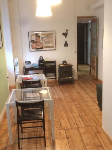 a living room with a table and chairs and a stove at La Terrazza Di Arturo Guest House in Turin