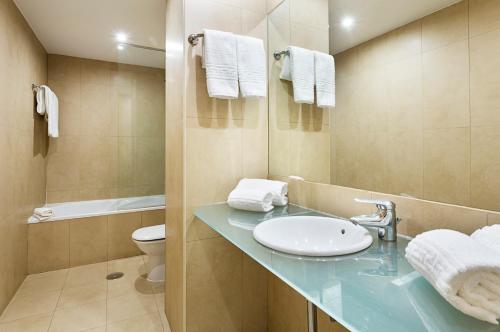 a bathroom with a sink, toilet and mirror at B&B Hotel Vigo in Vigo