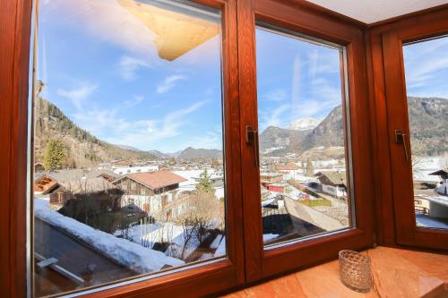 a window with a view of a city and mountains at Ferienwohnungen Wartbichler in Lofer