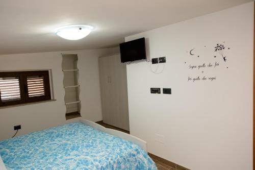 a bedroom with a bed and a tv on the wall at Vico 59 in Ortona
