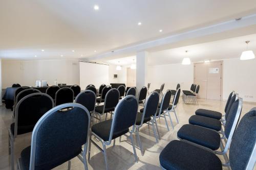 an empty room with chairs and a podium at Hotel Garibaldi in Palermo