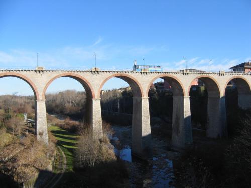 a bridge with many arches over a river at B&B Doria Valle Maira in Roccabruna
