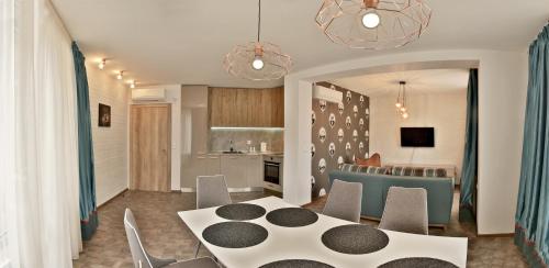 a kitchen and dining room with a table and chairs at Black Sea Royal Villa in Rogachevo