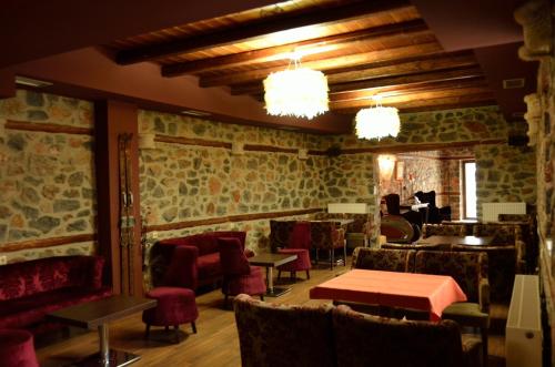 a restaurant with tables and chairs in a room at Gioras Hotel in Palaios Agios Athanasios