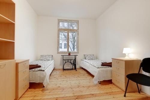 a bedroom with two beds and a window at Riga Academic Guest House in Riga