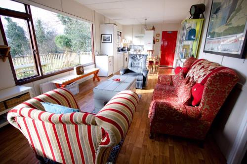 a living room with two chairs and a couch at Erinona Chalet in Kesh