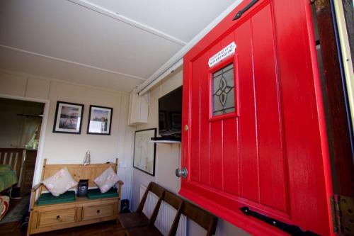 a red door in a room with a table at Erinona Chalet in Kesh
