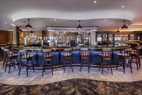 a bar in a hotel with chairs and a counter at The Glencarn Hotel in Castleblayney