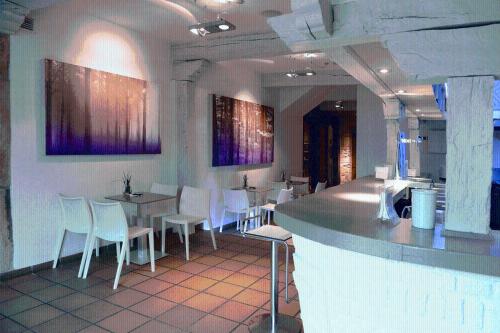 a restaurant with white chairs and tables and a bar at Los Guardeses in Solares