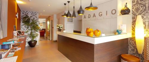 a kitchen with a large counter top and a large window at Hotel Adagio in Knokke-Heist