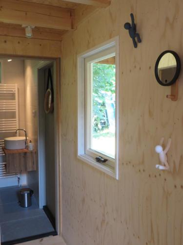 a room with a window in a tiny house at Casa Koudekerke in Koudekerke