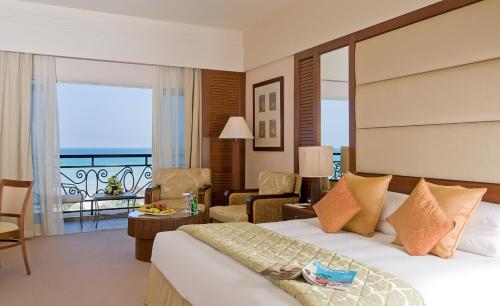 a hotel room with a bed and a balcony at Danat Jebel Dhanna Resort in Jebel Dhanna
