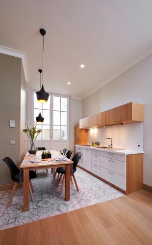 a kitchen with a wooden table and a dining room at Bubble 8 in Épernay