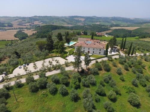 an aerial view of a house on a hill with trees at Villa Le Calvane in Montespertoli