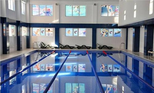 a large swimming pool in a building at New City Hotel in Masazır